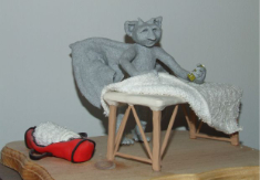 image of a gargoyle lifting the draped sheet on a massage table